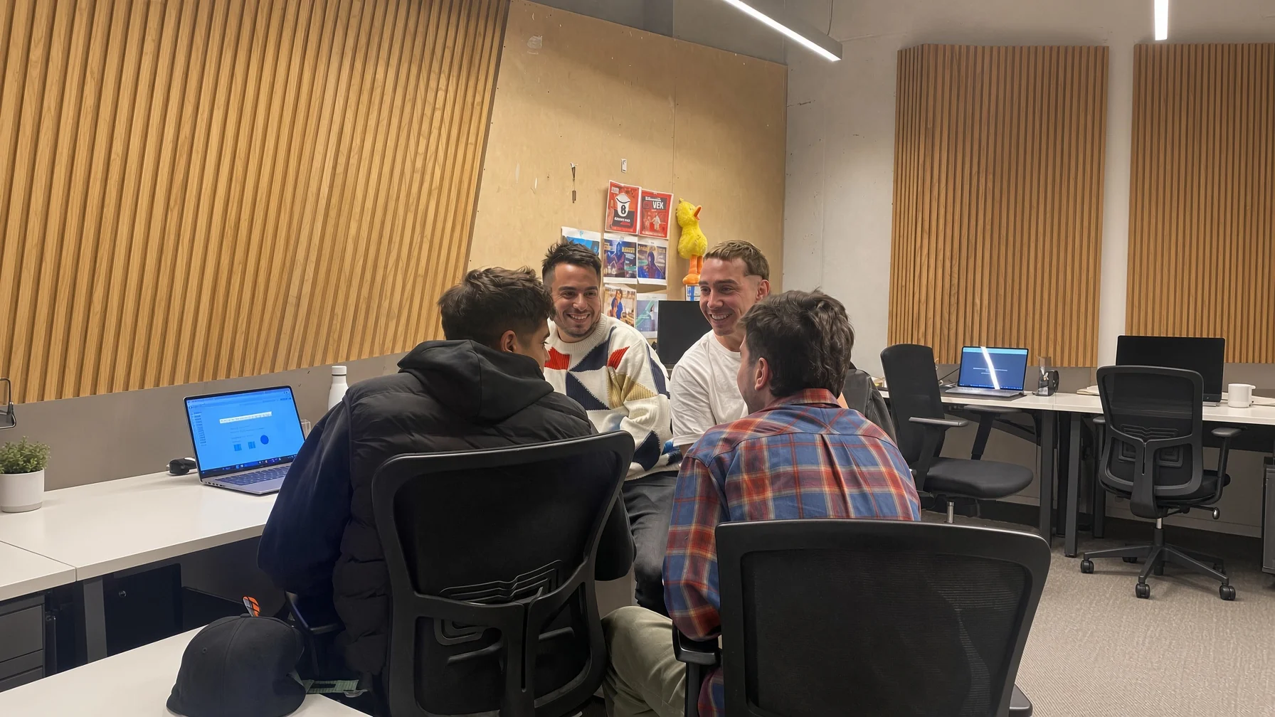 People sharing a work conversation in a creative space